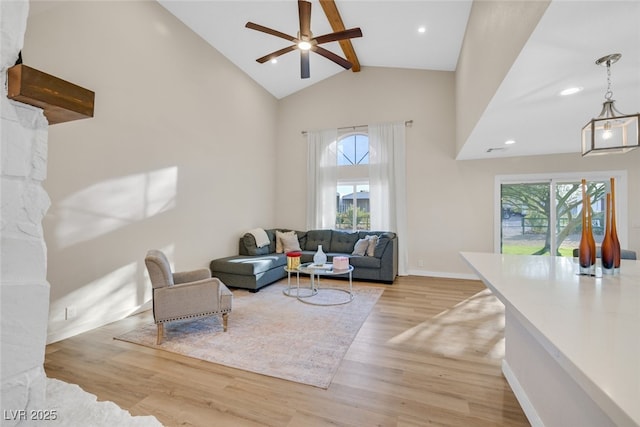 living room featuring high vaulted ceiling, a wealth of natural light, beam ceiling, and light hardwood / wood-style flooring