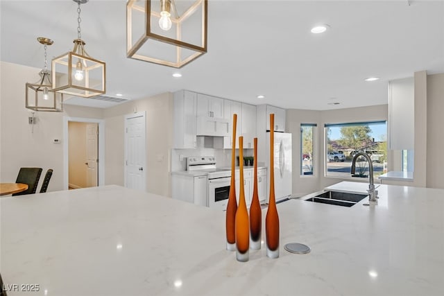 kitchen with ventilation hood, sink, white cabinets, hanging light fixtures, and white appliances