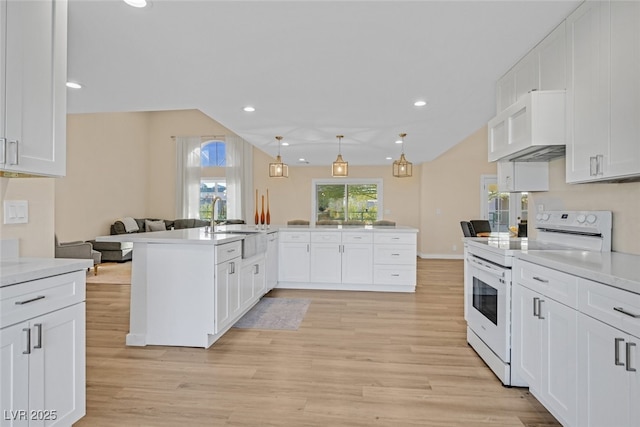 kitchen featuring decorative light fixtures, white cabinets, light wood-type flooring, and electric stove