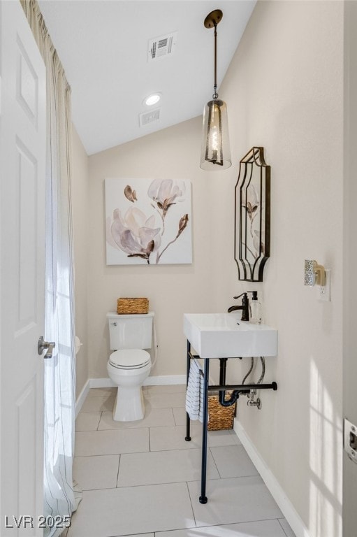 bathroom with sink, lofted ceiling, toilet, and tile patterned flooring