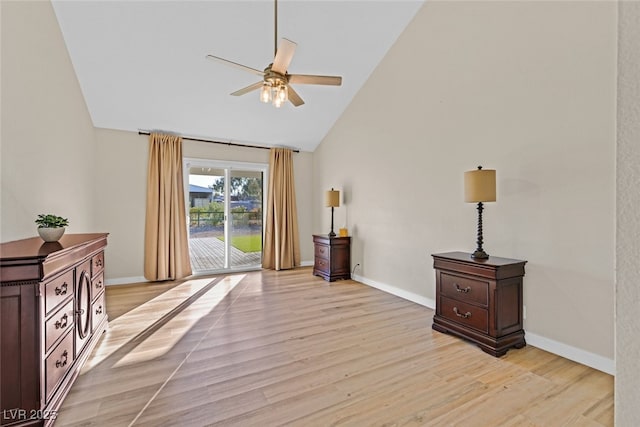 living area featuring ceiling fan, high vaulted ceiling, and light wood-type flooring