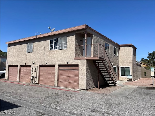 rear view of property featuring a garage