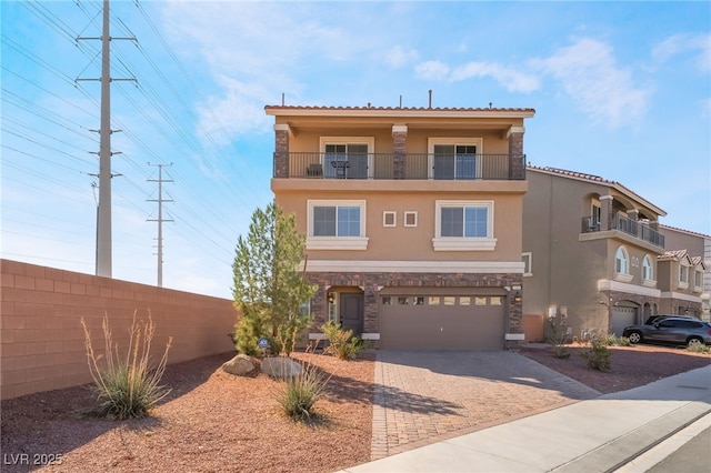 view of front of house with a garage and a balcony