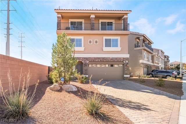 view of front of home featuring a garage and a balcony