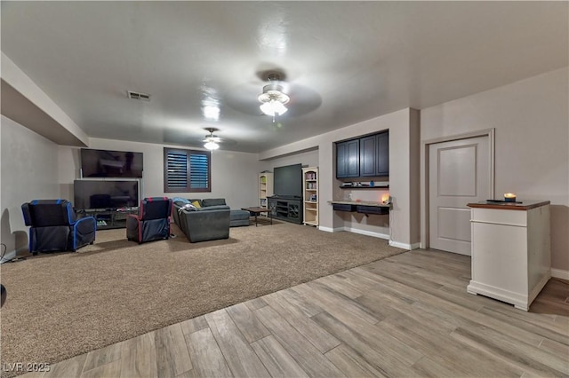 living room featuring hardwood / wood-style flooring and ceiling fan