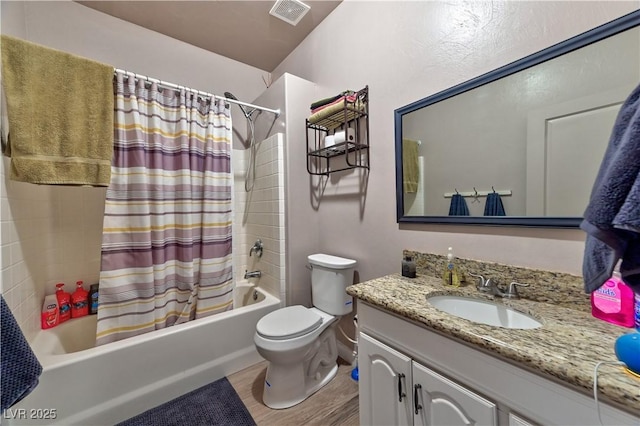 full bathroom with wood-type flooring, toilet, shower / bath combo with shower curtain, and vanity