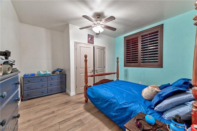 bedroom with ceiling fan and light hardwood / wood-style floors