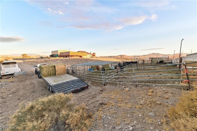 view of yard featuring a mountain view, a rural view, and an outdoor structure