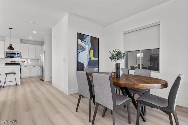 dining space with light wood-type flooring