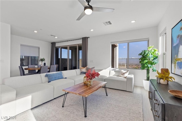 living room with ceiling fan and light hardwood / wood-style floors