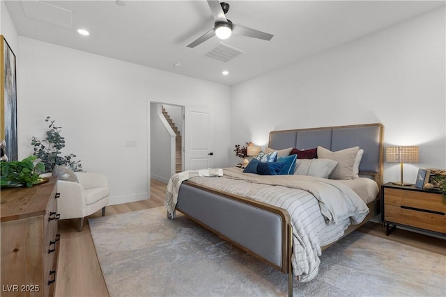 bedroom with ceiling fan and light wood-type flooring