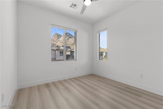 spare room featuring ceiling fan and light hardwood / wood-style floors