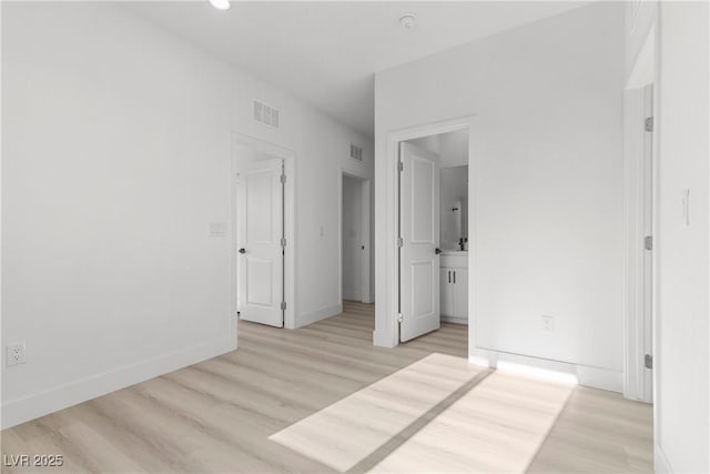 unfurnished bedroom featuring light wood-type flooring