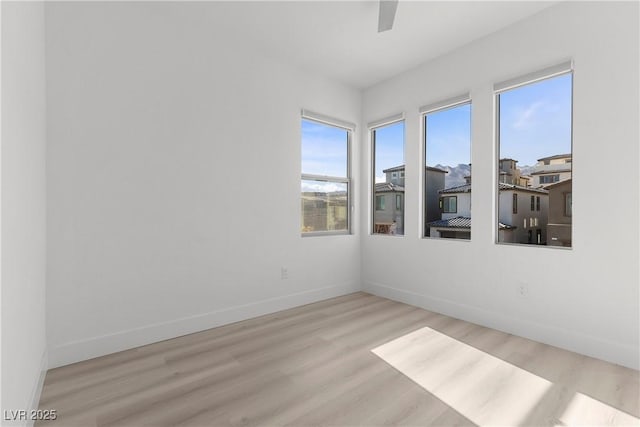 empty room featuring ceiling fan and light wood-type flooring