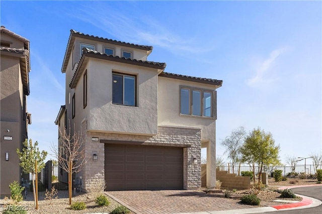 mediterranean / spanish home featuring a garage