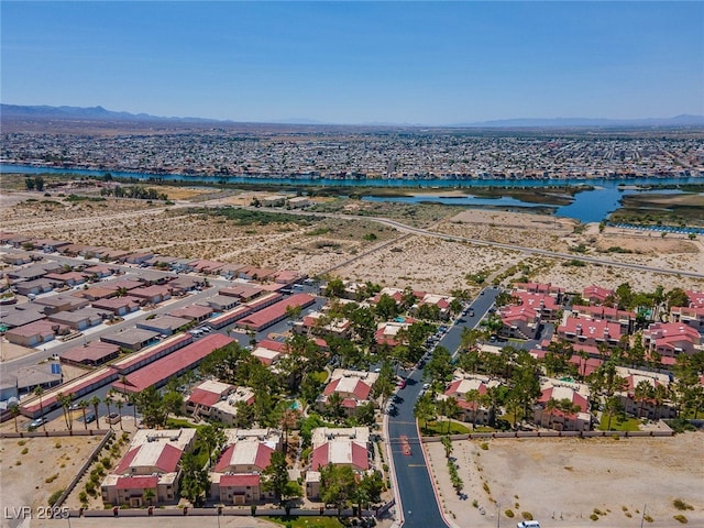 drone / aerial view featuring a water and mountain view