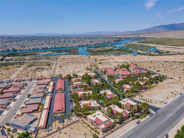 birds eye view of property with a water and mountain view