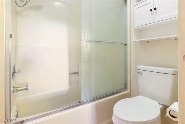 bathroom with bath / shower combo with glass door and toilet