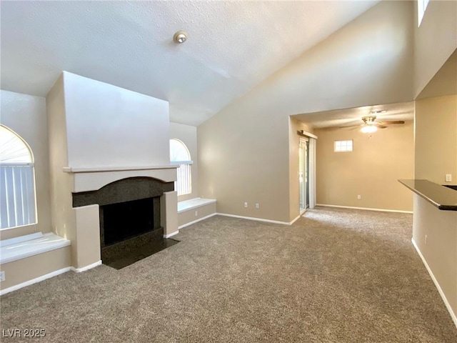 unfurnished living room with high vaulted ceiling, carpet floors, a textured ceiling, and ceiling fan