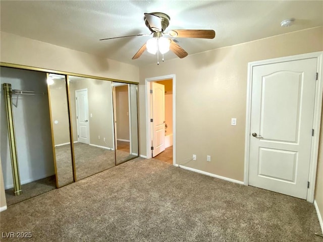 unfurnished bedroom featuring carpet floors, ceiling fan, and ensuite bathroom