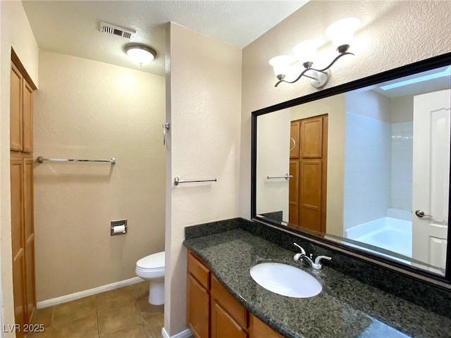 full bathroom featuring bathing tub / shower combination, vanity, a textured ceiling, tile patterned floors, and toilet