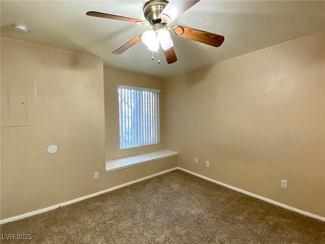 carpeted spare room with electric panel and ceiling fan