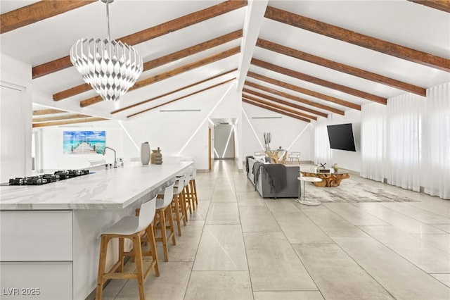 living room featuring an inviting chandelier, light tile patterned flooring, and lofted ceiling with beams