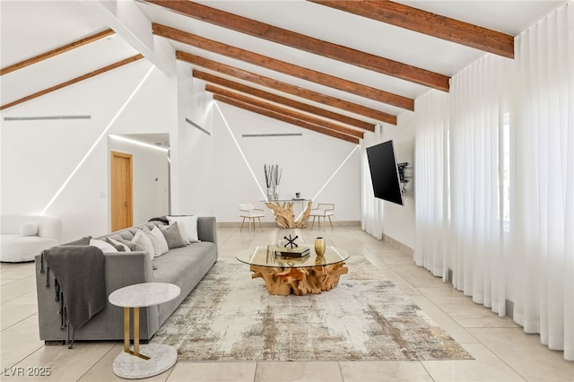 living room featuring vaulted ceiling with beams and light tile patterned flooring