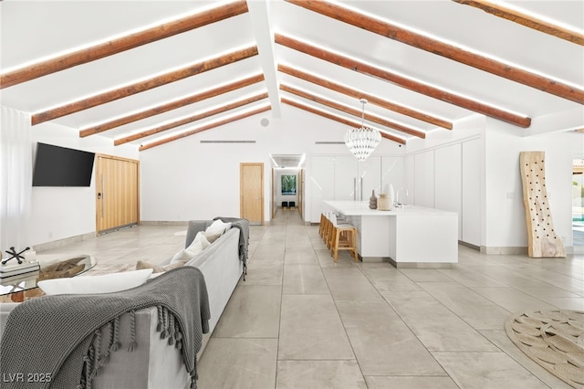 living room with a notable chandelier and lofted ceiling with beams