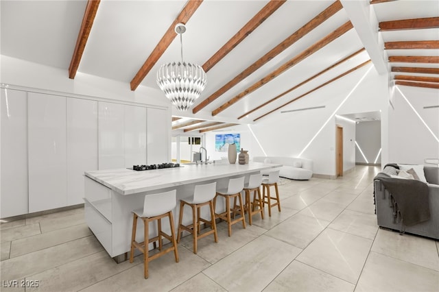 kitchen featuring pendant lighting, sink, white cabinetry, and a spacious island