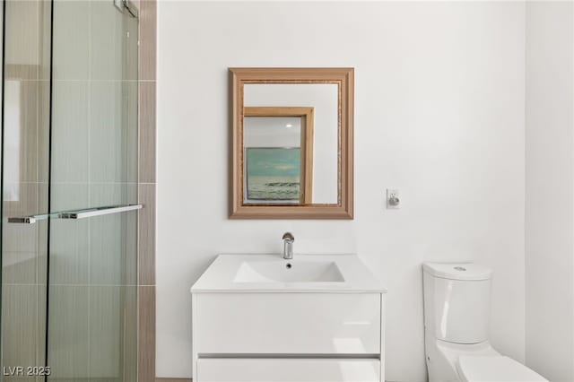 bathroom with vanity, toilet, and an enclosed shower