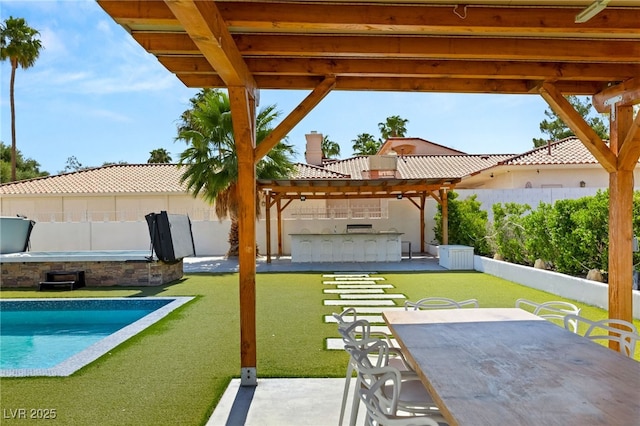 view of patio featuring a fenced in pool and an outdoor bar