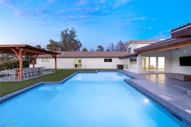 view of pool featuring a lawn and a patio