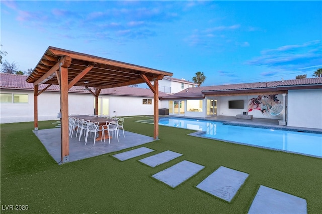 view of pool featuring a patio, a yard, and an outdoor bar