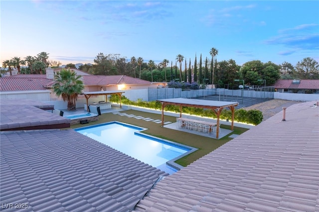 pool at dusk with an outdoor bar