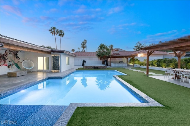 view of pool with a pergola, a patio area, and a lawn