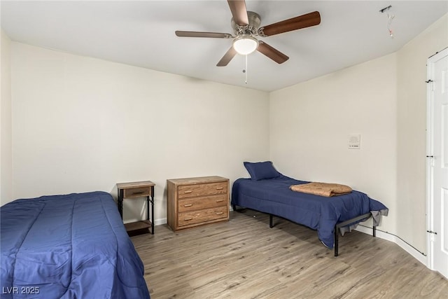 bedroom with ceiling fan and light hardwood / wood-style flooring