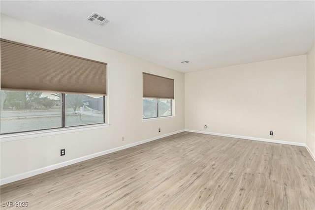 unfurnished room with light hardwood / wood-style floors