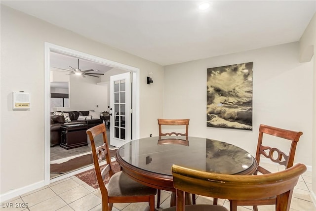 tiled dining room featuring ceiling fan