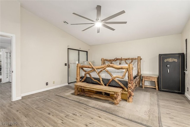 bedroom with ceiling fan, wood-type flooring, and lofted ceiling