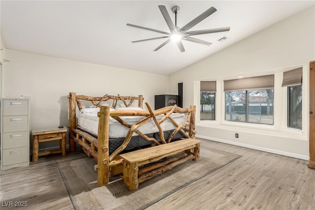 bedroom with hardwood / wood-style floors, vaulted ceiling, and ceiling fan