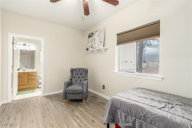 bedroom with hardwood / wood-style flooring, ceiling fan, and connected bathroom