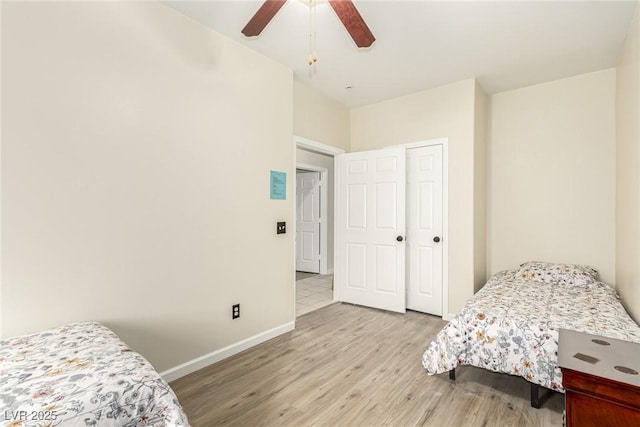 bedroom featuring ceiling fan, light hardwood / wood-style flooring, and a closet