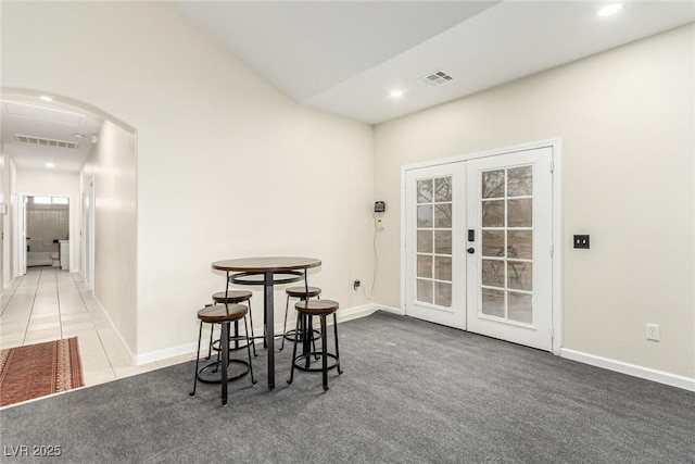 dining space with french doors and carpet floors