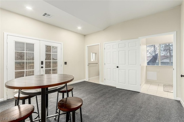 dining room with french doors and dark carpet