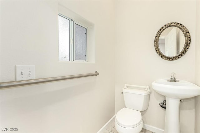 bathroom featuring sink, tile patterned flooring, and toilet