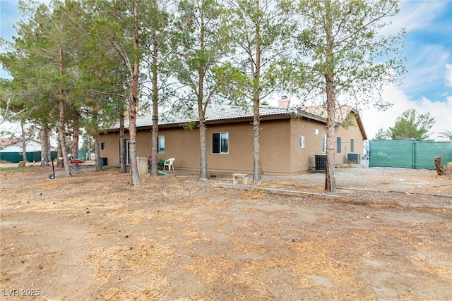 rear view of house featuring central air condition unit