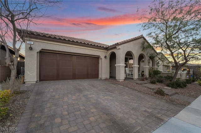 mediterranean / spanish house with a garage