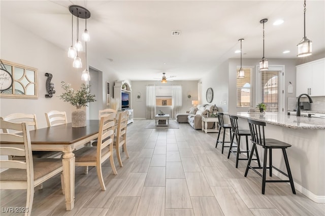 dining space with sink and ceiling fan