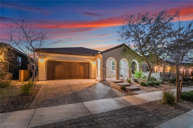 mediterranean / spanish home with a garage